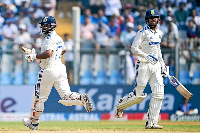 India's Rishabh Pant (L) and Shubman Gill run between the wickets during the second day of the third and final Test cricket match between India and New Zealand at the Wankhede Stadium in Mumbai on 2 November, 2024