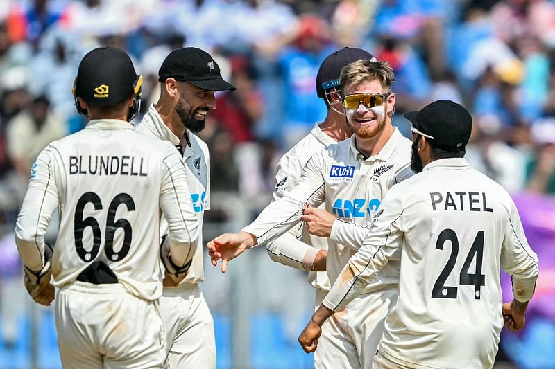 New Zealand's Glenn Phillips (2L) celebrates with teammates after taking the wicket of India's Akash Deep during the third day of the third and final Test cricket match between India and New Zealand at the Wankhede Stadium in Mumbai on 3 November, 2024.