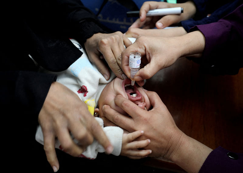 A Palestinian child is vaccinated against polio during the second round of a vaccination campaign, amid the Israel-Hamas conflict, in Gaza City, on 2 November 2024