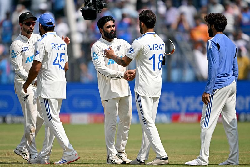 New Zealand's Ajaz Patel (3L) and Devon Conway (L) shake hands with India's Virat Kohli (2R) and captain Rohit Sharma (2L) at the end of the third and final Test cricket match between India and New Zealand at the Wankhede Stadium in Mumbai on November 3, 2024