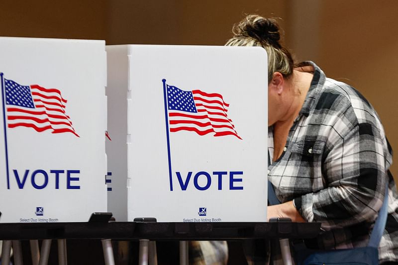 A woman votes at a polling location at The Chapel, an Evangelical church in St. Joseph, Michigan, on Election Day, 5 November, 2024.