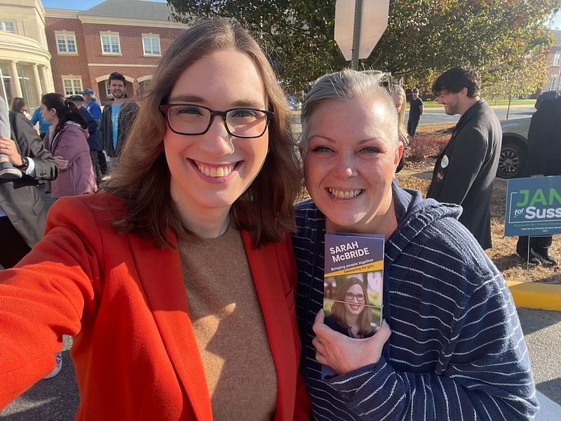 Democrat Sarah McBride (red coat) takes a selfie with a supporter