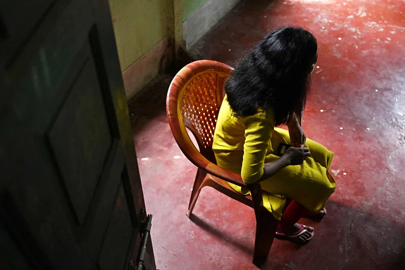 A young Indian woman, rescued from sexual exploitation, speaks with AFP at a house provided by an NGO in Kolkata.