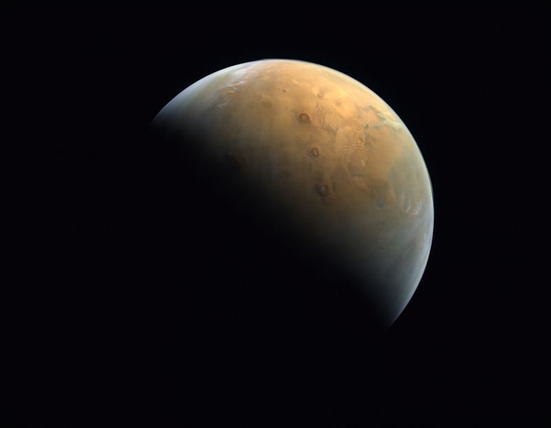 A handout picture provided on 14 February, 2021 by the United Arab Emirates Space Agency (UAESA) taken by the Emirates eXploration Imager (EXI) after Mars Orbit Insertion (MOI) on board the First Emirates Mars Mission (EMM) from an altitude of 24,700 km above the Martian surface shows the Olympus Mons, the highest volcano on Mars, and the Tharsis Montes, three volcanoes named (top to bottom) Ascraeus Mons, Pavonis Mons and Arsia Mons. A Chinese rover has found new evidence to support the theory that Mars was once home to a vast ocean, including tracing some ancient coastline where water may once have lapped, a study said on 7 November, 2024.