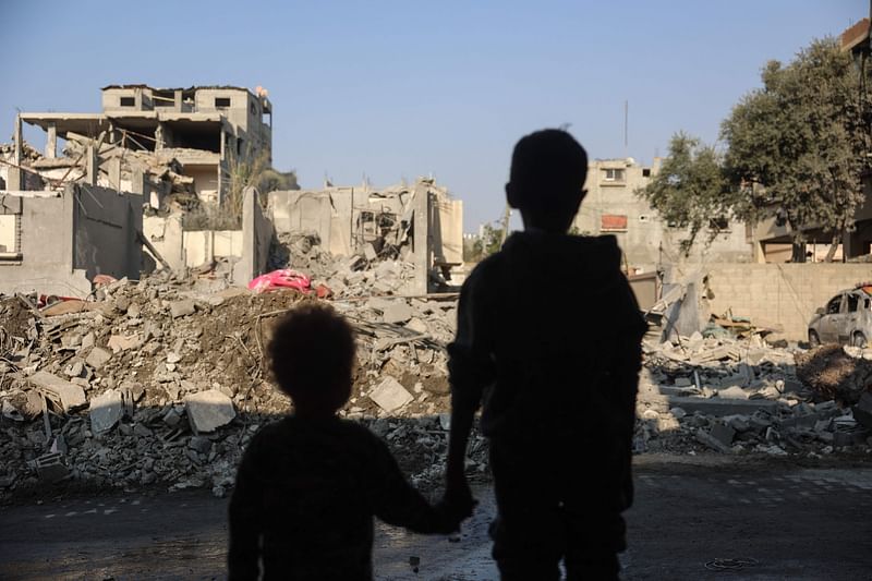 Children stare at the destruction following an Israeli strike in the Nuseirat refugee camp in the central Gaza Strip on 7 November, 2024, amid the ongoing war between Israel and Palestinian Hamas militants.