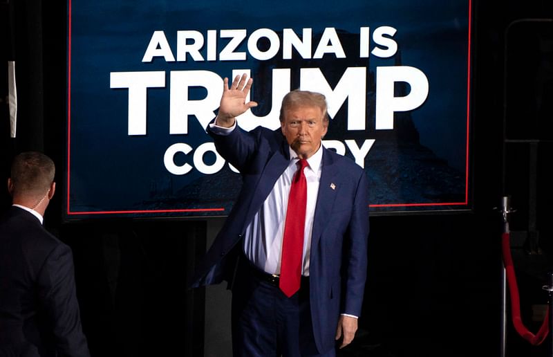 Former US President and Republican presidential candidate Donald Trump waves as he leaves after speaking during a campaign event at the Tucson Music Hall in Tucson, Arizona, 12 September, 2024. Donald Trump won the state of Arizona in this week's US presidential election, US TV networks projected on 9 November, 2024, completing the Republican's sweep of all seven swing states.