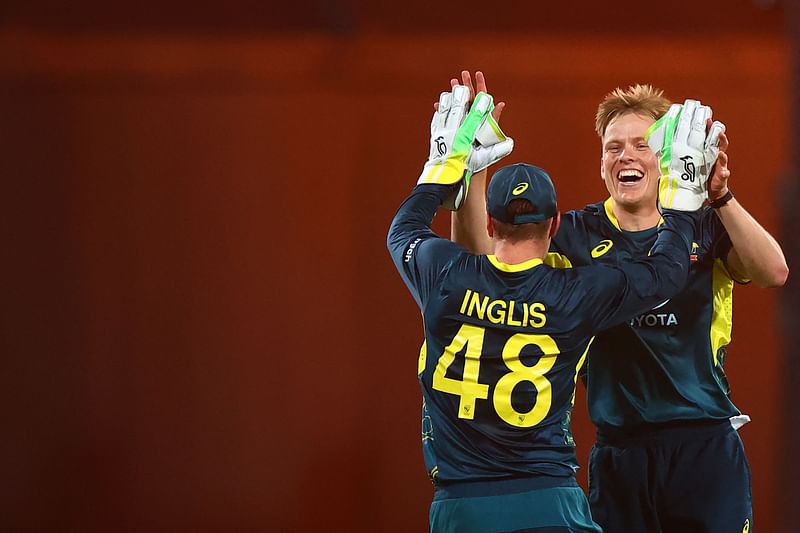 Australia's Nathan Ellis (R) celebrates the wicket of Pakistan's Mohammad Irfan Khan with teammate Josh Inglis during the first Twenty20 international cricket match between Australia and Pakistan at The Gabba in Brisbane on November 14, 2024