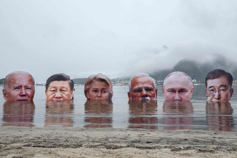 (L to R) Giant portraits of US President Joe Biden, China's President Xi Jinping, President of the European Commission Ursula von der Leyen, India's Prime Minister Narendra Modi, Russia's President Vladimir Putin, and Japan's Prime Minister Shigeru Ishiba are submerged by indigenous people to protest the lack of leadership among the world's richest nations on addressing the climate and biodiversity crisis in Rio de Janeiro, Brazil, on 16 November, 2024, ahead of the G20 Summit.