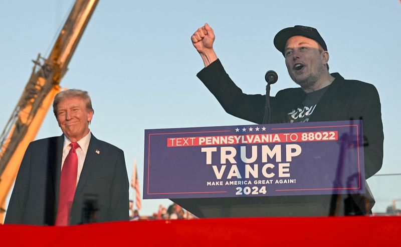 Tesla CEO Elon Musk (R) speaks on stage as he joins former US President and Republican presidential candidate Donald Trump during a campaign rally at site of his first assassination attempt in Butler, Pennsylvania on 5 October 2024