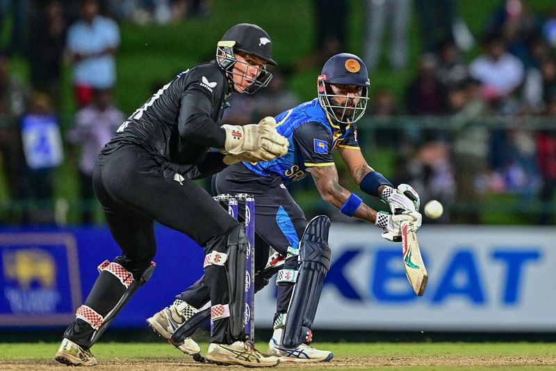 Sri Lanka's Kusal Mendis (R) plays a shot during the second one-day international (ODI) cricket match between Sri Lanka and New Zealand at the Pallekele International Cricket Stadium in Kandy on November 17, 2024.