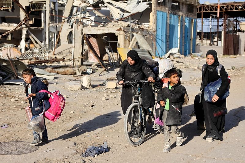 Displaced Palestinians fleeing Beit Lahia in the northern Gaza Strip walk on the main Salah al-Din road on November 17, 2024, amid the ongoing war between Israel and the militant Hamas group.