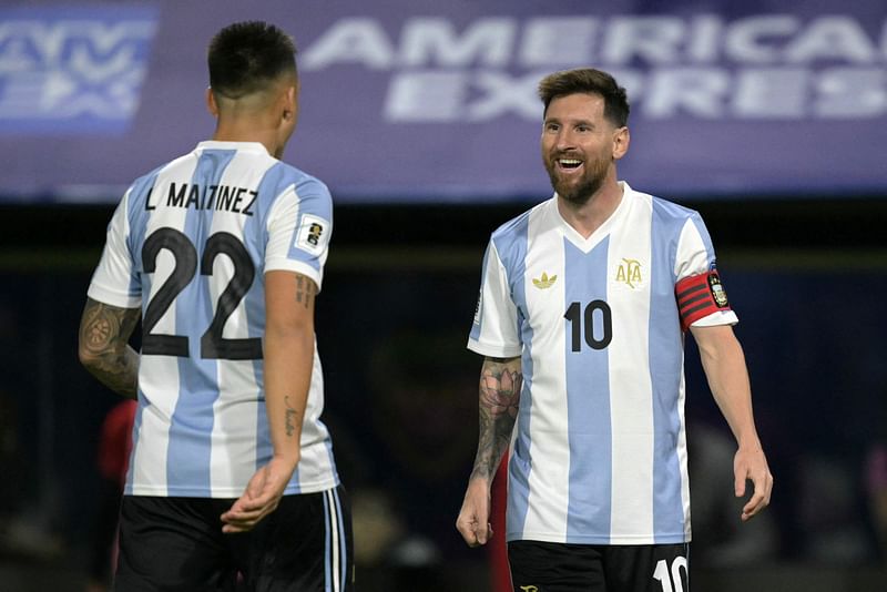 Argentina’s forward #22 Lautaro Martinez celebrates with Argentina’s forward #10 Lionel Messi after scoring during the 2026 FIFA World Cup South American qualifiers football match between Argentina and Peru at the La Bombonera stadium in Buenos Aires on 19 November 2024