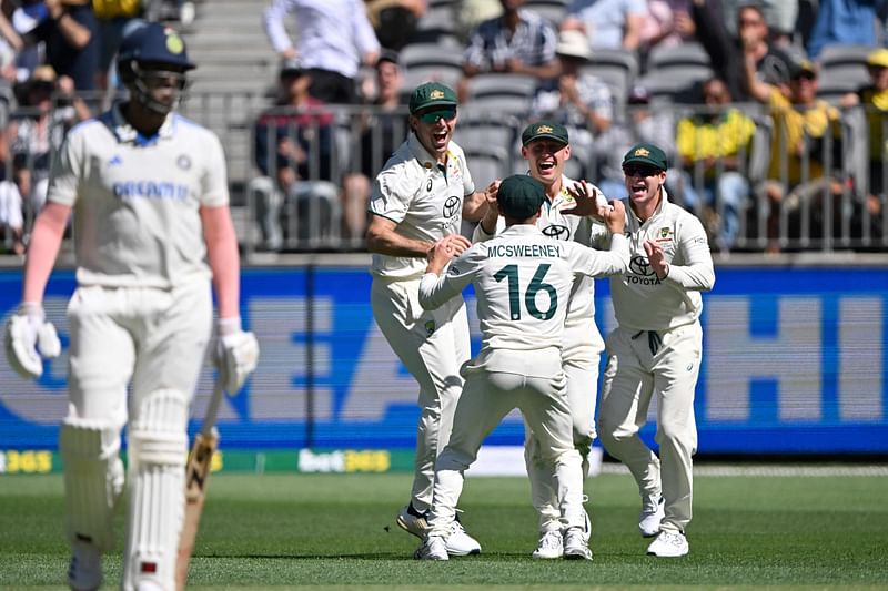 Australia’s Marnus Labuschagne (C) celebrates his catch of India's Harshit Rana with teammates during the first day of the first Test cricket match between Australia and India at the Optus Stadium in Perth on 22 November, 2024.