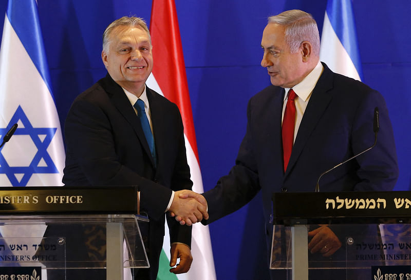 In this file photo taken on 19 February 2019 Hungarian Prime Minister Viktor Orban (L) and Israeli Prime Minister Benjamin Netanyahu shake hands during a press conference after their meeting in Jerusalem