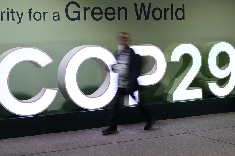 An attendee walks past the COP29 logo during the United Nations Climate Change Conference (COP29) in Baku, Azerbaijan, on 21 November 2024.