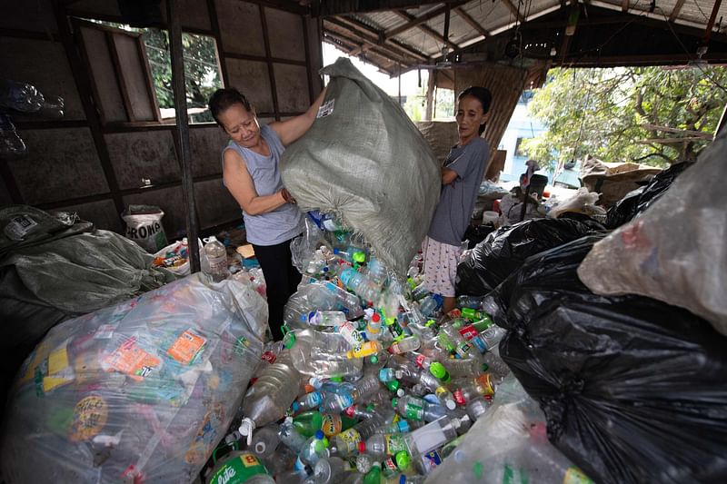 Workers segragate plastic bottles at a junk yard in Manila on November 7, 2024. Plastic pollution litters our seas, our air and even our bodies, but negotiators face an uphill battle next week to agree the world's first treaty aimed at ending the problem