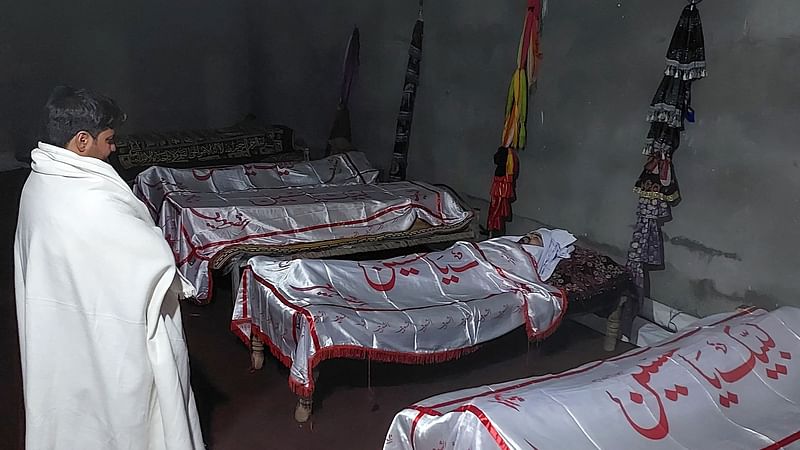 A mourner stands beside the dead bodies of victims who were killed in sectarian attacks in Kurram district at a Shitte Muslim mosque in Parachinar, the mountainous Khyber Pakhtunkhwa province, on 22 November, 2024