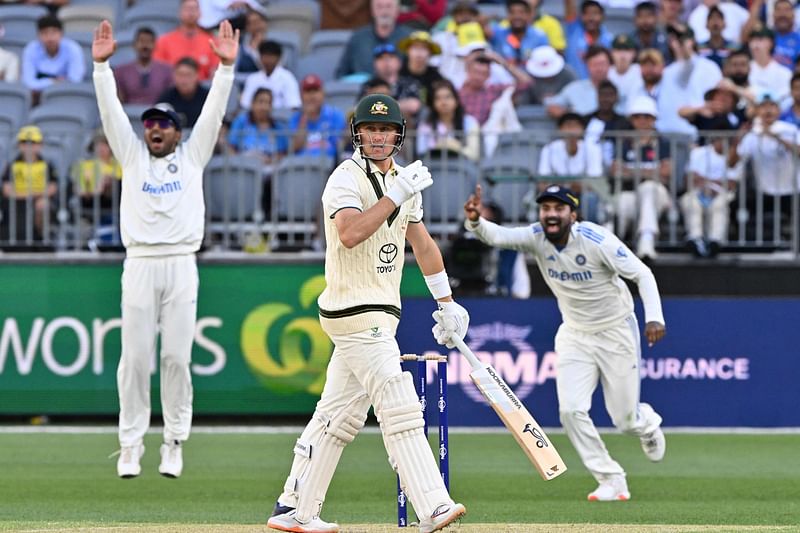 Australia's Marnus Labuschagne (C) walks off after his dismissal during the first day of the first Test cricket match between Australia and India at the Optus Stadium in Perth on 22 November, 2024.