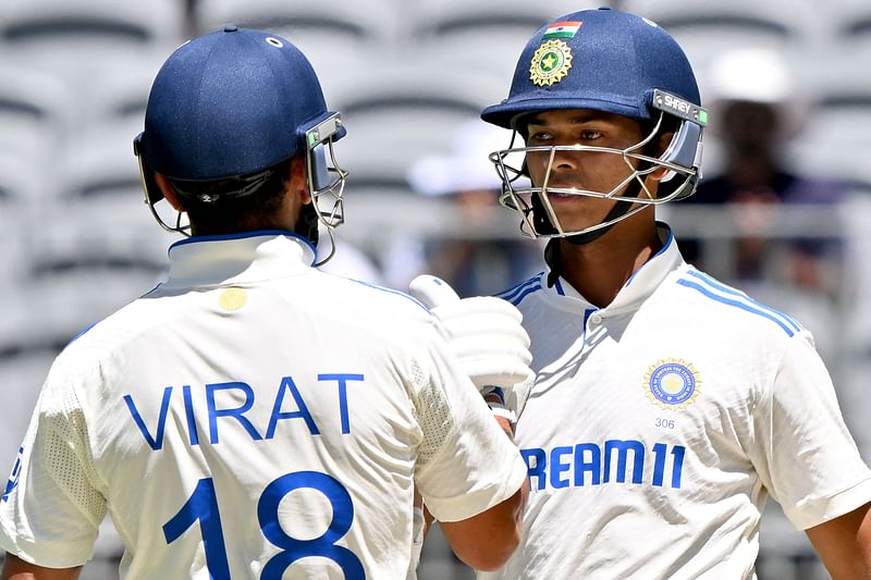 India’s Virat Kohli (L) greets Yashasvi Jaiswal for the latter’s 150 runs on day three of the first Test cricket match between Australia and India at Optus Stadium in Perth on 24 November 2024