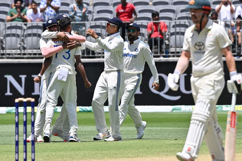 India's Mohammed Siraj (L) celebrates the wicket of Australia's Steve Smith with teammates on day four of the first Test cricket match between Australia and India at Optus Stadium in Perth on 25 November, 2024.