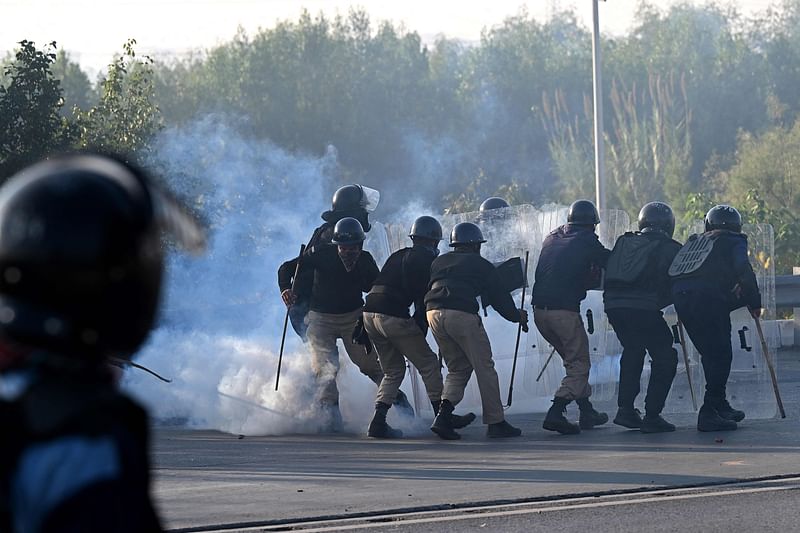 Policemen fire tear gas shells to disperse supporters of Pakistan Tehreek-e-Insaf (PTI) party during a protest to demand the release of former prime minister Imran Khan, in Islamabad on November 26, 2024