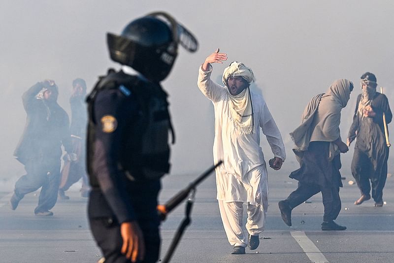 A supporter of Pakistan Tehreek-e-Insaf (PTI) party gestures after tear gas was fired by the police to disperse the crowd during a protest to demand the release of former prime minister Imran Khan in Islamabad on 26 November, 2024.