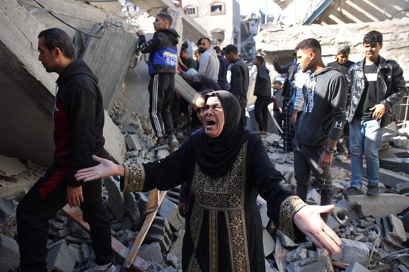 A Palestinian woman reacts as she stands amid the rubble of a building destroyed in an Israeli strike on the Shujaiyah neighbourhood in Gaza City in the northern Gaza Strip on November 30, 2024, during the ongoing war between Israel and the Hamas