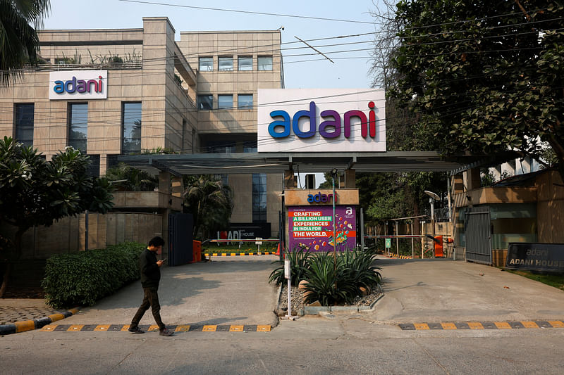 A man walks past a corporate office of Adani Group in Gurugram, India, 22 November 2024.