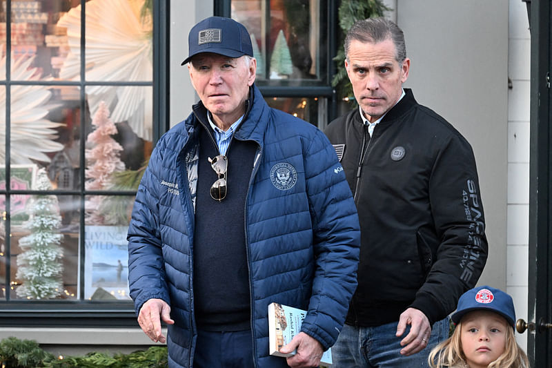 US President Joe Biden, accompanied by Hunter Biden and Beau Jr., walks out of a bookstore in downtown Nantucket, Massachusetts, US, 29 November 2024.