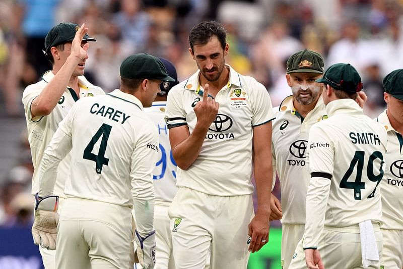 Australian bowler Mitchell Starc (C) celebrates dismissing Ravichandran Ashwin of India on the first day of the second cricket Test match between Australia and India at the Adelaide Oval in Adelaide on 6 December, 2024.