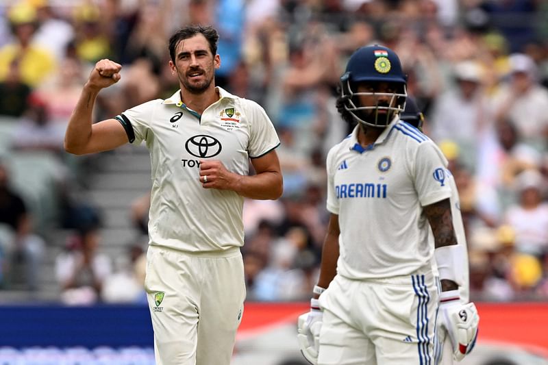 Australian bowler Mitchell Starc (L) celebrates dismissing Indian batsman KL Rahul (R) on the first day of the second cricket Test match between Australia and India at the Adelaide Oval in Adelaide on 6 December, 2024