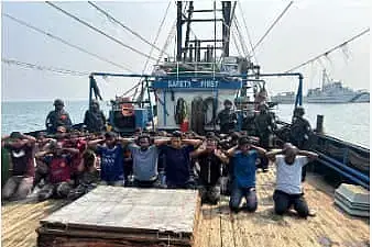 In one of the photos, the detained sailors are seen kneeling on the deck of a vessel with their hands behind their heads and the Indian Coast Guard members standing behind them.