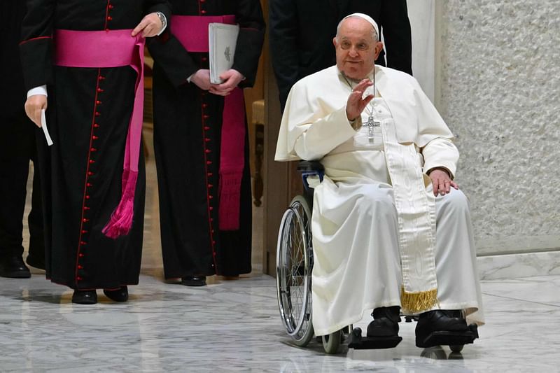 Pope Francis waves as he arrives for the weekly general audience at Paul-VI hall in The Vatican, on December 11, 2024