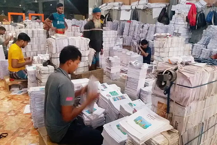 Workers at a press in the capital's Matuail busy in binding free textbooks