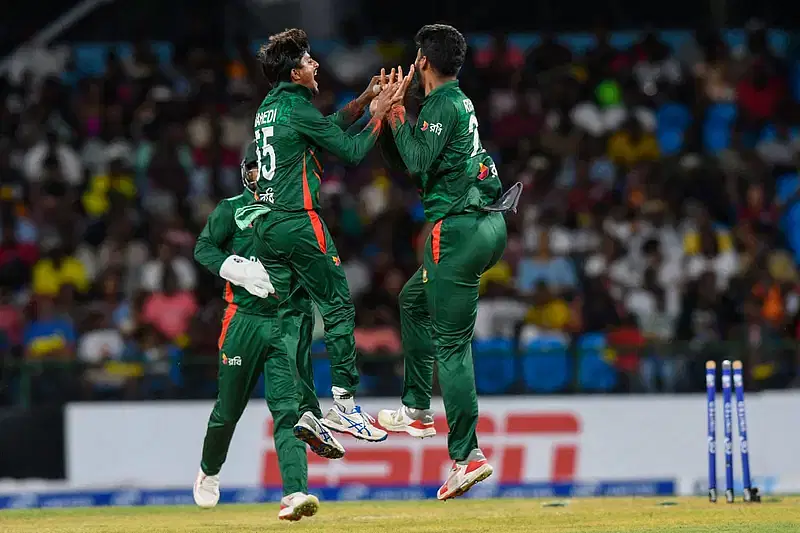 Off-spinner Mahedi Hasan (L) and leg spinner Rishad Hossain celebrate a wicket of West Indies in the first T20I