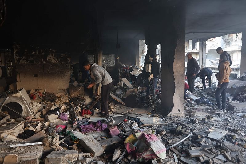 Palestinians inspect the damage at the site of an Israeli airstrike on a building in Gaza City's Daraj neighbourhood on 17 December, 2024, amid the ongoing war between Israel and Hamas militants.