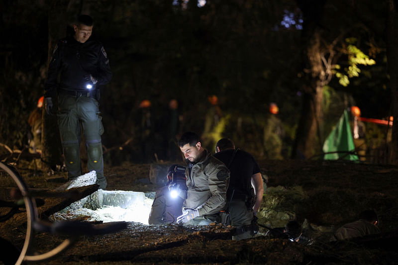 Israeli emergency services work at the scene of a missile strike that, according to Israeli military, was launched from Yemen and landed in Jaffa, south of Tel Aviv, Israel, on 21 December, 2024.