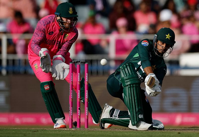 Pakistan's Saim Ayub (R) plays a shot past South Africa's wicketkeeper Heinrich Klaasen during the third one day international (ODI) cricket match batween South Africa and Pakistan at The Wanderers Stadium in Johannesburg on December 22, 2024