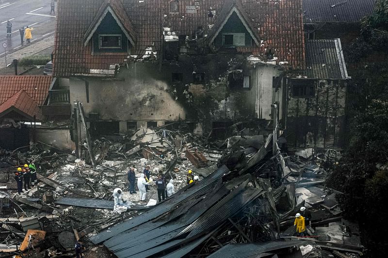 Firefighters and other rescue teams work in the site of a plane crash at the city of Gramado, Rio Grande do Sul state, Brazil, on December 22, 2024