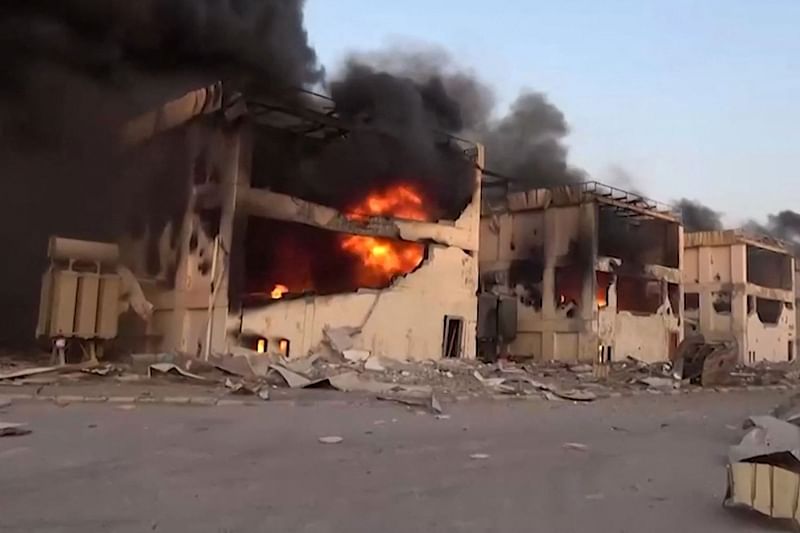 An image grab from a handout video provided by Yemen's Huthis' official Al-Masirah TV station on 26 December, 2024, shows burning buildings following Israeli strikes on the Ras Kutaib power station in Hodeida.