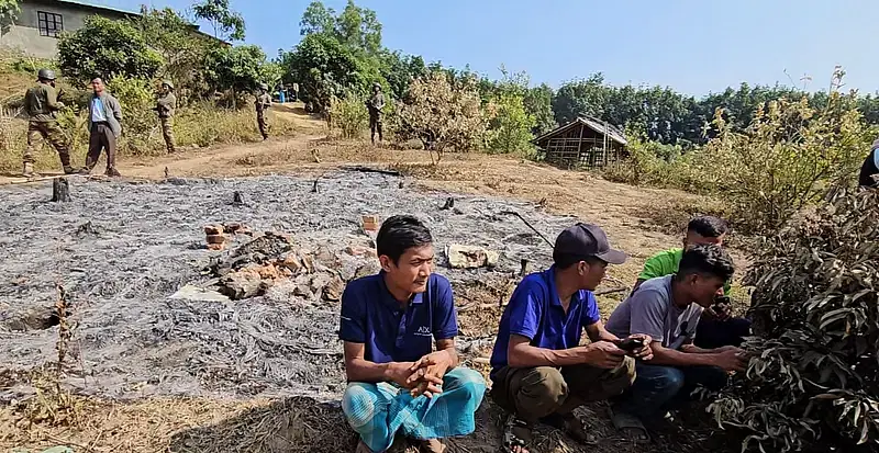 Some of residents of the Tripura community in Sarai Union of Lama upazila in Bandarban sit near their burnt down house. Photo taken on 26 December 2024.