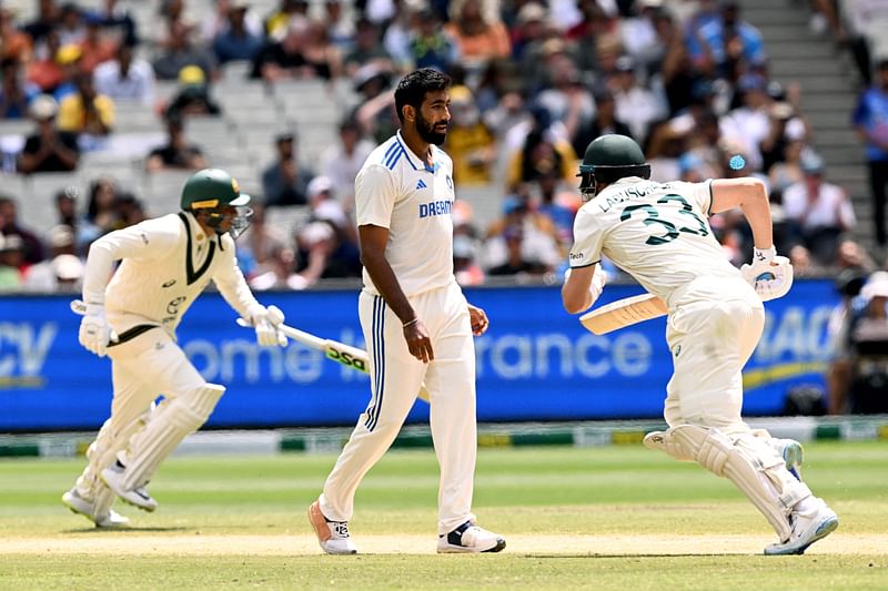 Indian bowler Jasprit Bumrah watches Australian batsmen Usman Khawaja and Marnus Labuschagne take runs on the fourth day of the fourth cricket Test match with Australia at the Melbourne Cricket Ground (MCG) in Melbourne on 29 December, 2024