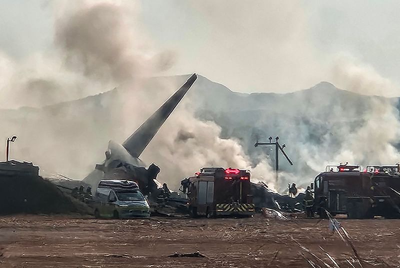 Smoke rises from the tail section of a Jeju Air Boeing 737-800 series aircraft after the plane crashed and burst into flames at Muan International Airport in South Jeolla Province, some 288 kilometres southwest of Seoul on 29 December, 2024.