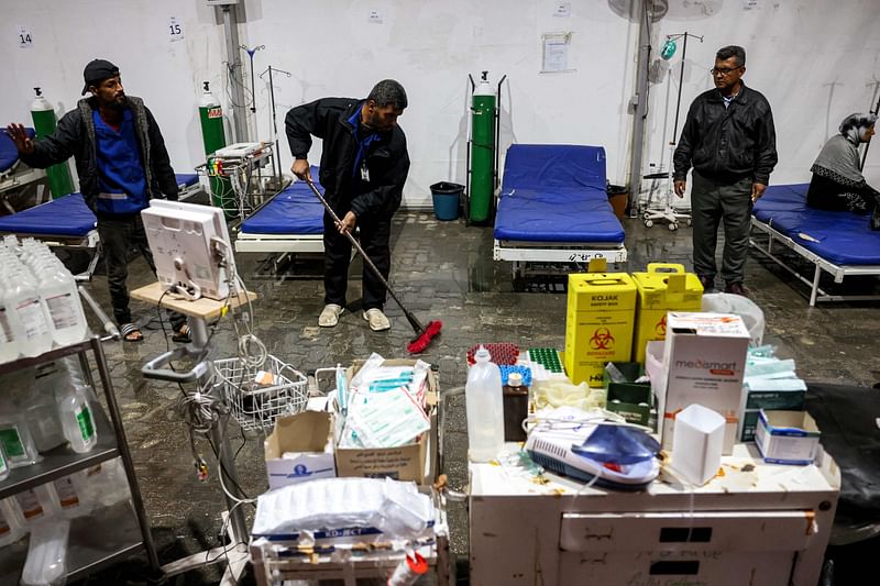 Men mop away the rainwater that flooded the medical tent annex at Nasser Medical Complex in Khan Yunis in the southern Gaza Strip due to a rainstorm on December 31, 2024 amid the ongoing war in the Palestinian territory between Israel and Hamas