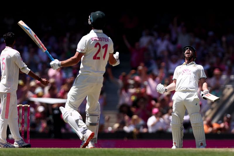 Australia’s Travis Head (R) and teammate Beau Webster react after they won the match on day three of the fifth cricket Test match between Australia and India at The SCG in Sydney on 5 January, 2025.