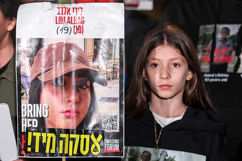 A relative of Liri Albag, an Israeli hostage taken captive by Palestinian militants to the Gaza Strip during the 7 October attacks, demonstrates with other family members in Tel Aviv on 4 January, 2025, calling for action to secure the release of the Israeli hostages amid the ongoing war in the Palestilian territory between Israel and Hamas. The Ezzedine al-Qassam Brigades, Hamas' armed wing, released a video of the Israeli hostage on 4 January, 2025. In the undated, three-and-half-minute video recording that AFP has not been able to verify, Albag called in Hebrew for the Israeli government to secure her release.