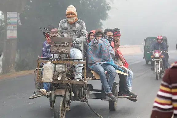 Working people wrapped in warm clothes brave the cold as they head out for work on a three-wheeler. The photo was taken from the Manoharpur area of the Pabna-Ishwardi highway on 6 January 2024.