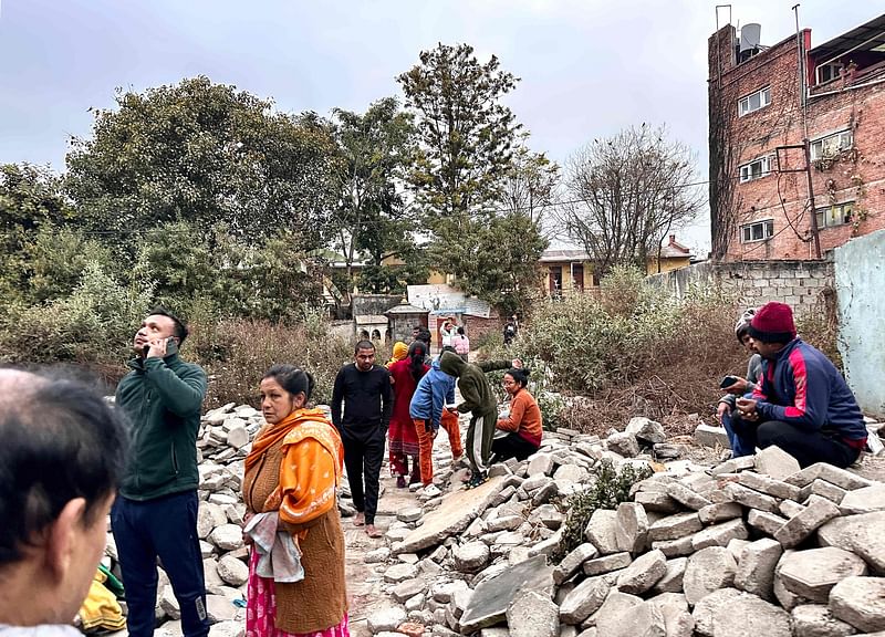 People gather in an open area following earthquake tremors in Kathmandu, in the early hours on 7 January 2025