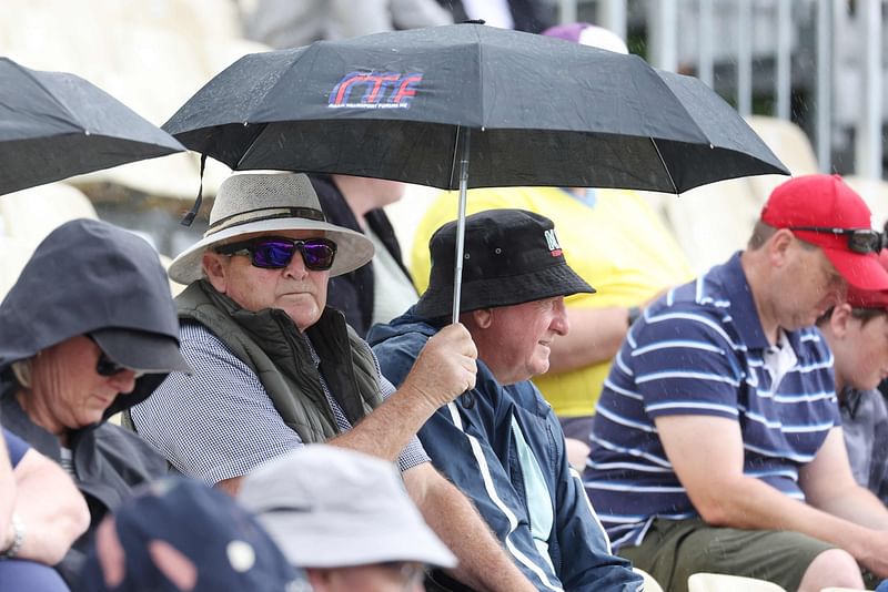 Fans shelter as rain delays the start of the second one-day international cricket match between New Zealand and Sri Lanka at Seddon Park in Hamilton on 8 January 2025