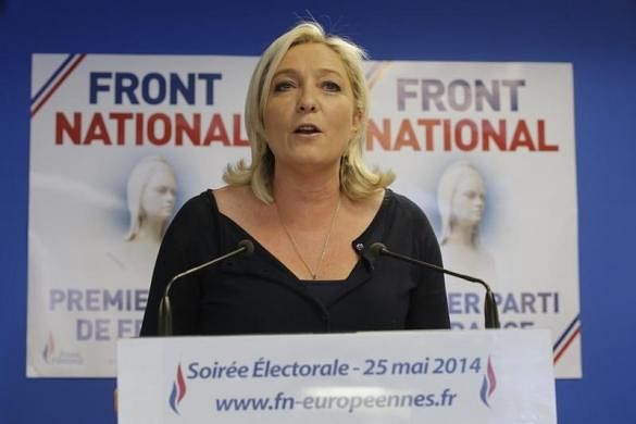 Marine Le Pen, France's National Front political party head, reacts to results after the polls closed in the European Parliament elections at the party's headquarters in Nanterre, near Paris